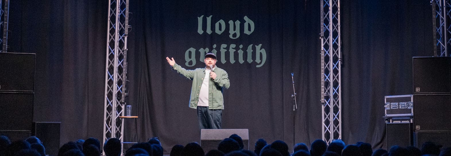 photo of comedian lloyd griffith performing on stage