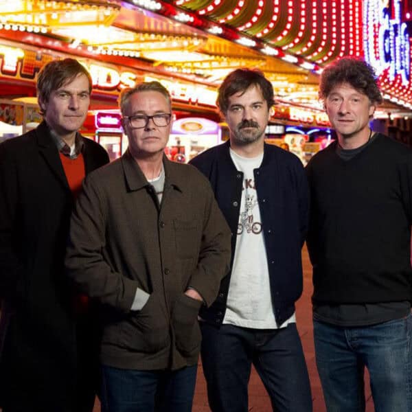 The Bluetones Docks Academy 2025 90s Indie band The Bluetones posed for a photograph infront of a seaside arcade